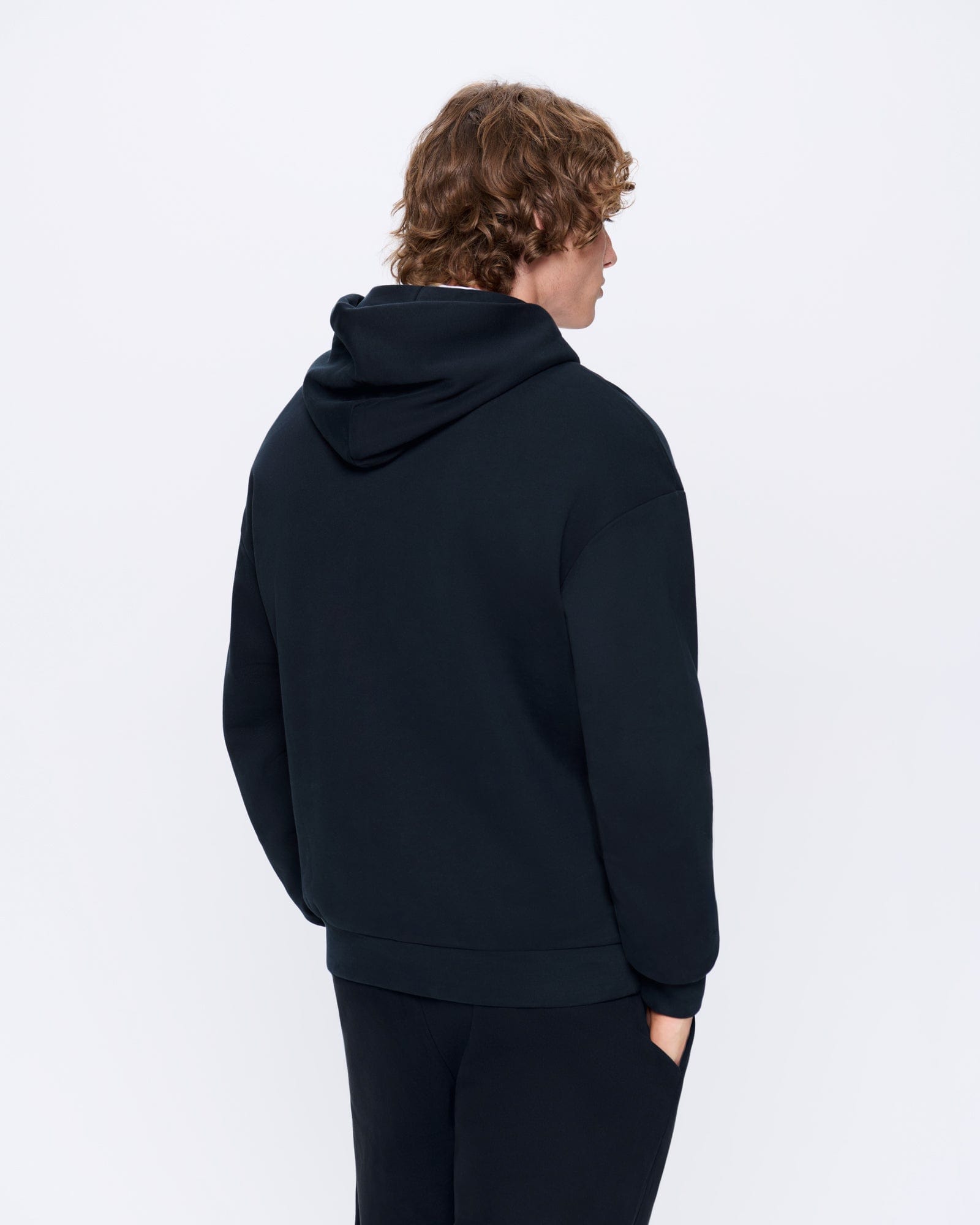 Men's dark navy oversized cotton blend fleece hoodie and matching sweatpants, shown from the back with a relaxed fit
