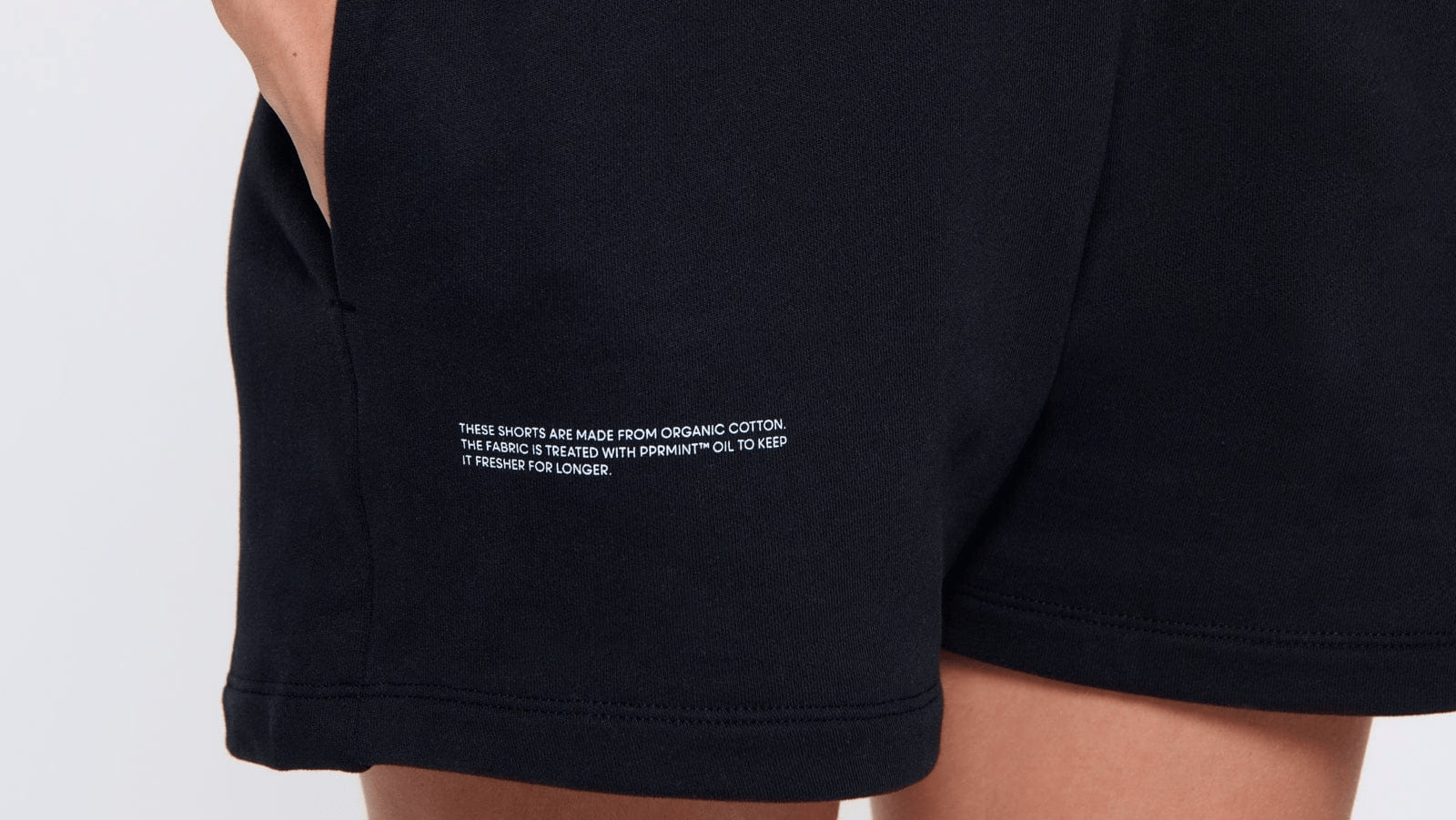 Premium black organic cotton sweat shorts with white PPRMINT™ treated text detail, relaxed fit
