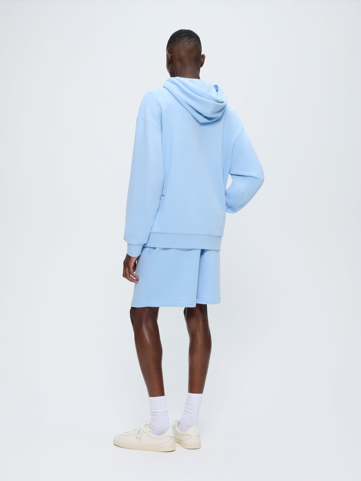 Mens 365 Midweight Mid Length Shorts Dewdrop Blue. Model from back, regular fit organic cotton shorts and matching hoodie