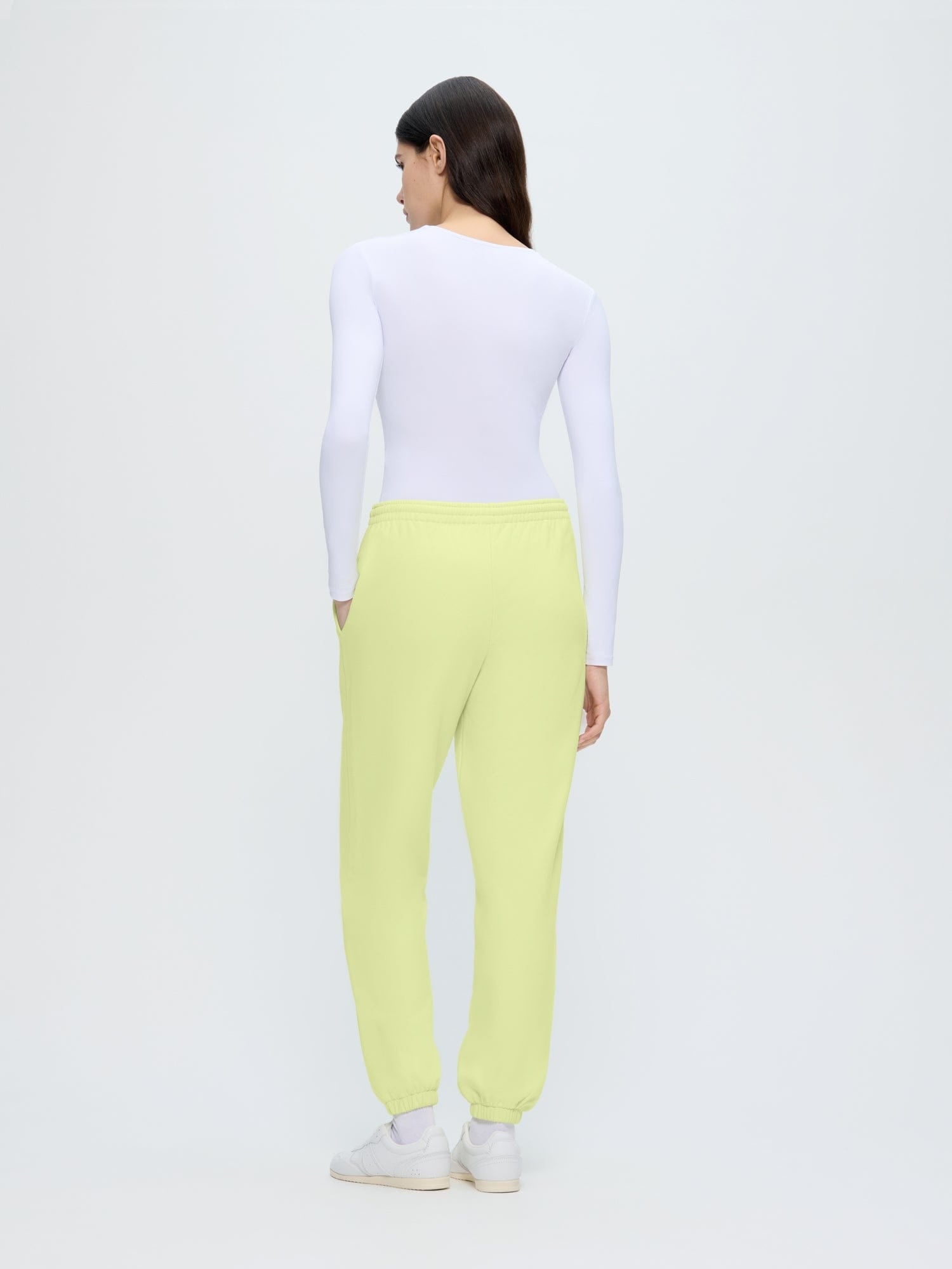 Womens 365 Midweight Track Pants in Soft Lime, loose fit organic cotton joggers, back view showing side pockets