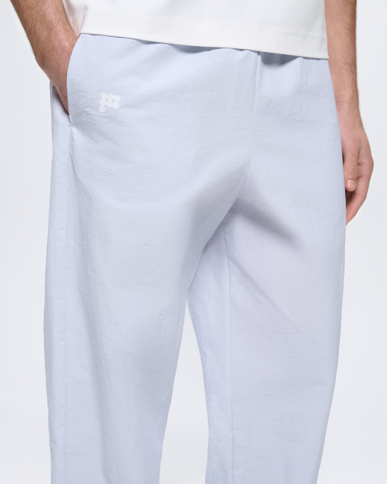 Mens Recycled Nylon Track Pants Ice Grey, oversized fit. Lightweight breathable fabric, white logo