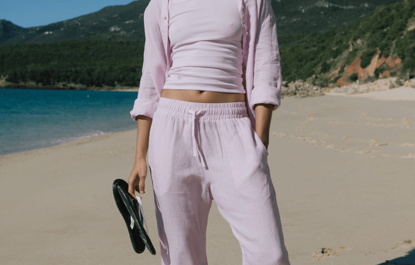 Women's lavender linen blend wide leg drawstring pants, ribbed square neck cropped top, and oversized button-up shirt.