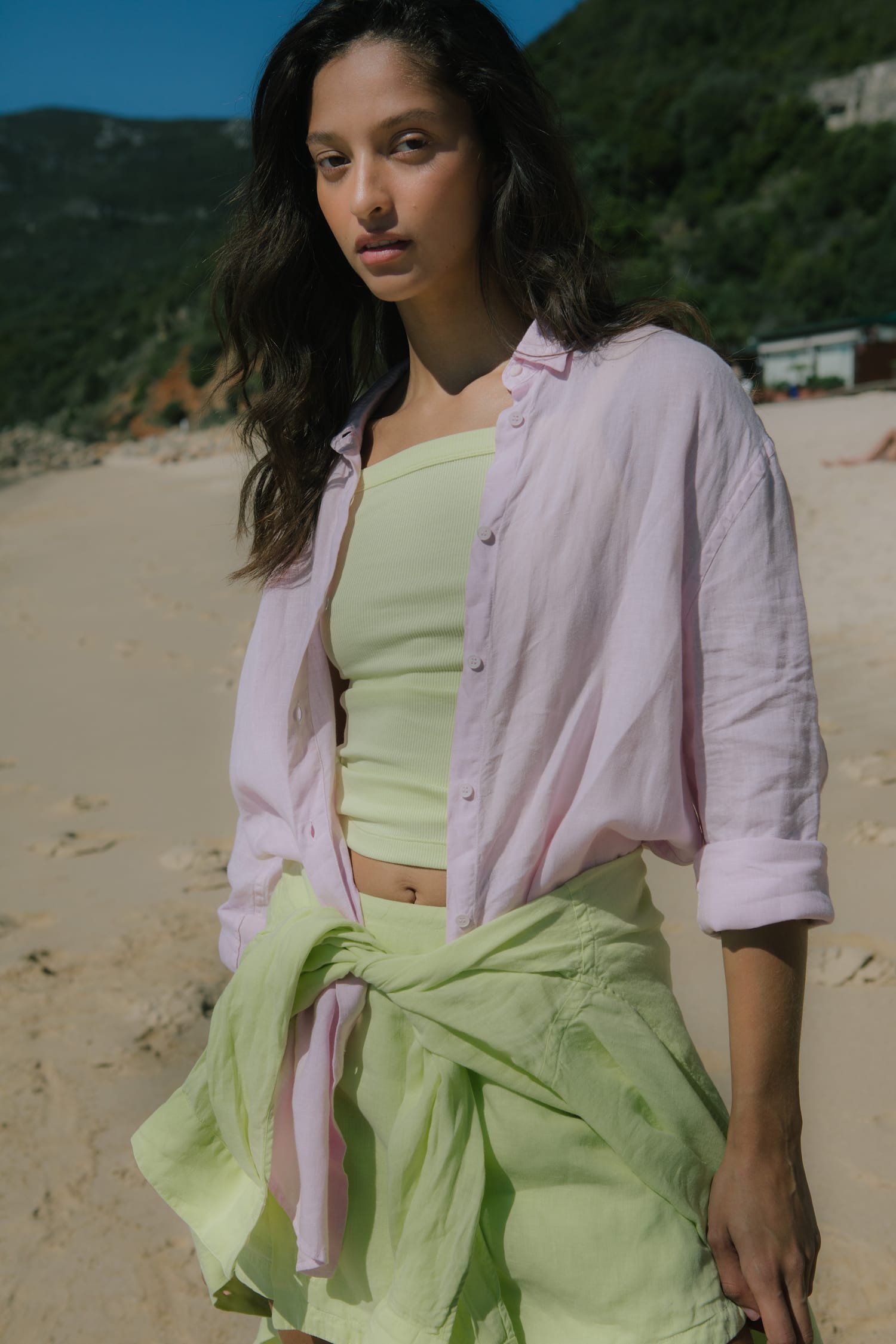 Pale pink oversized linen blend shirt, lime green ribbed tube top, matching lime green shorts tied on model