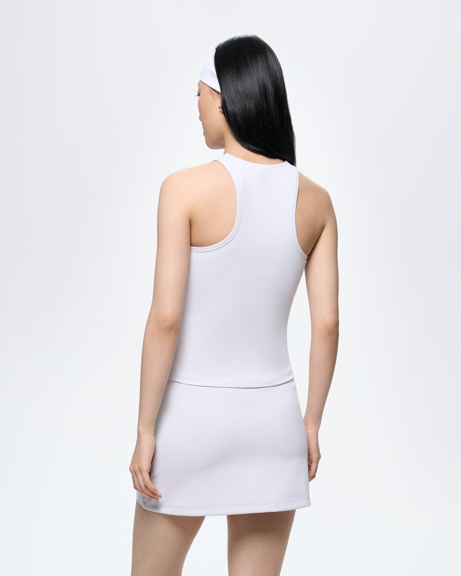 Womens Ice Grey Court Side Tank Top, model rear view. Ultra-close fit, racerback style, soft bio-based fabric