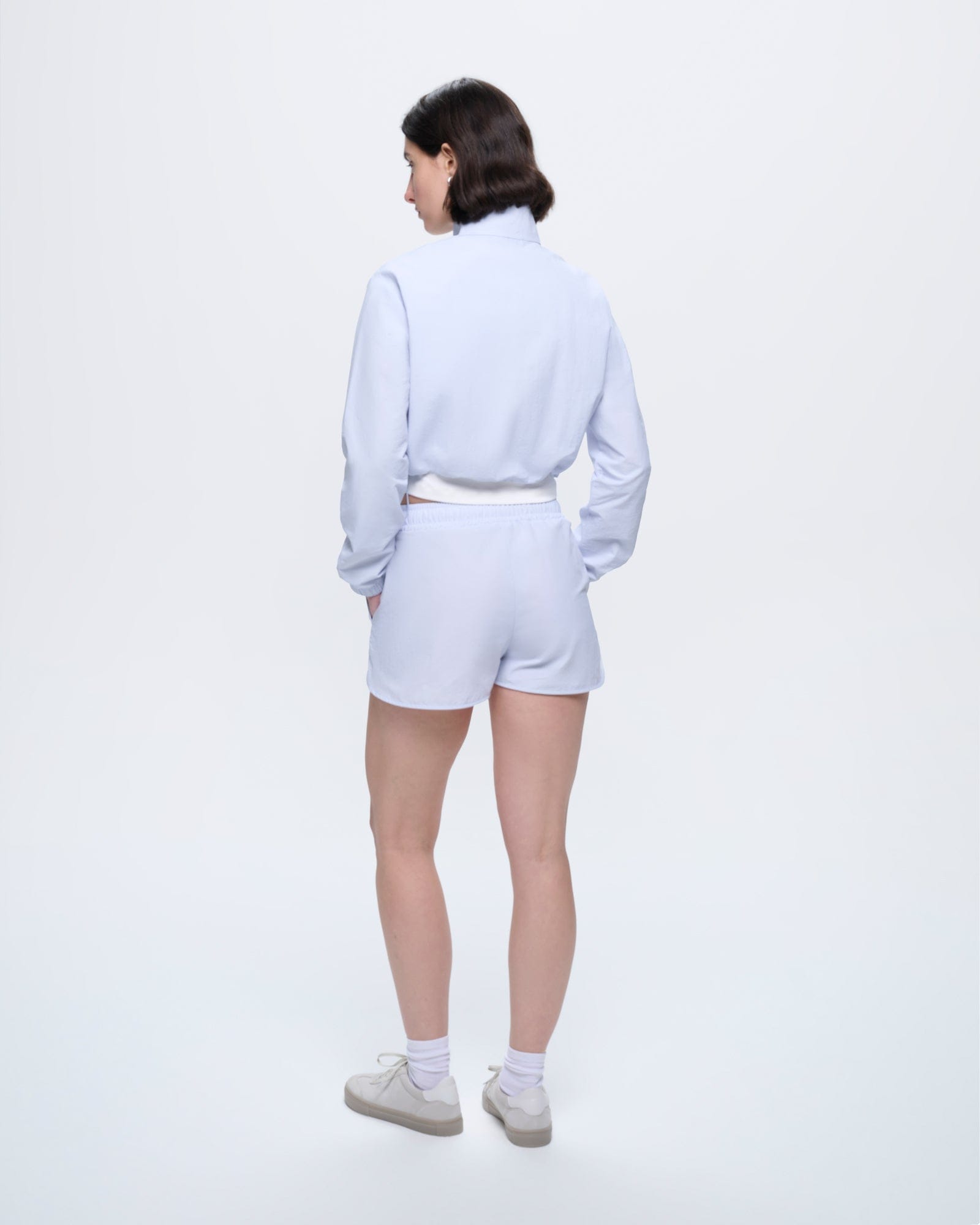 Womens Ice Grey Recycled Nylon Shorts, regular fit, lightweight, breathable training shorts. Model from behind