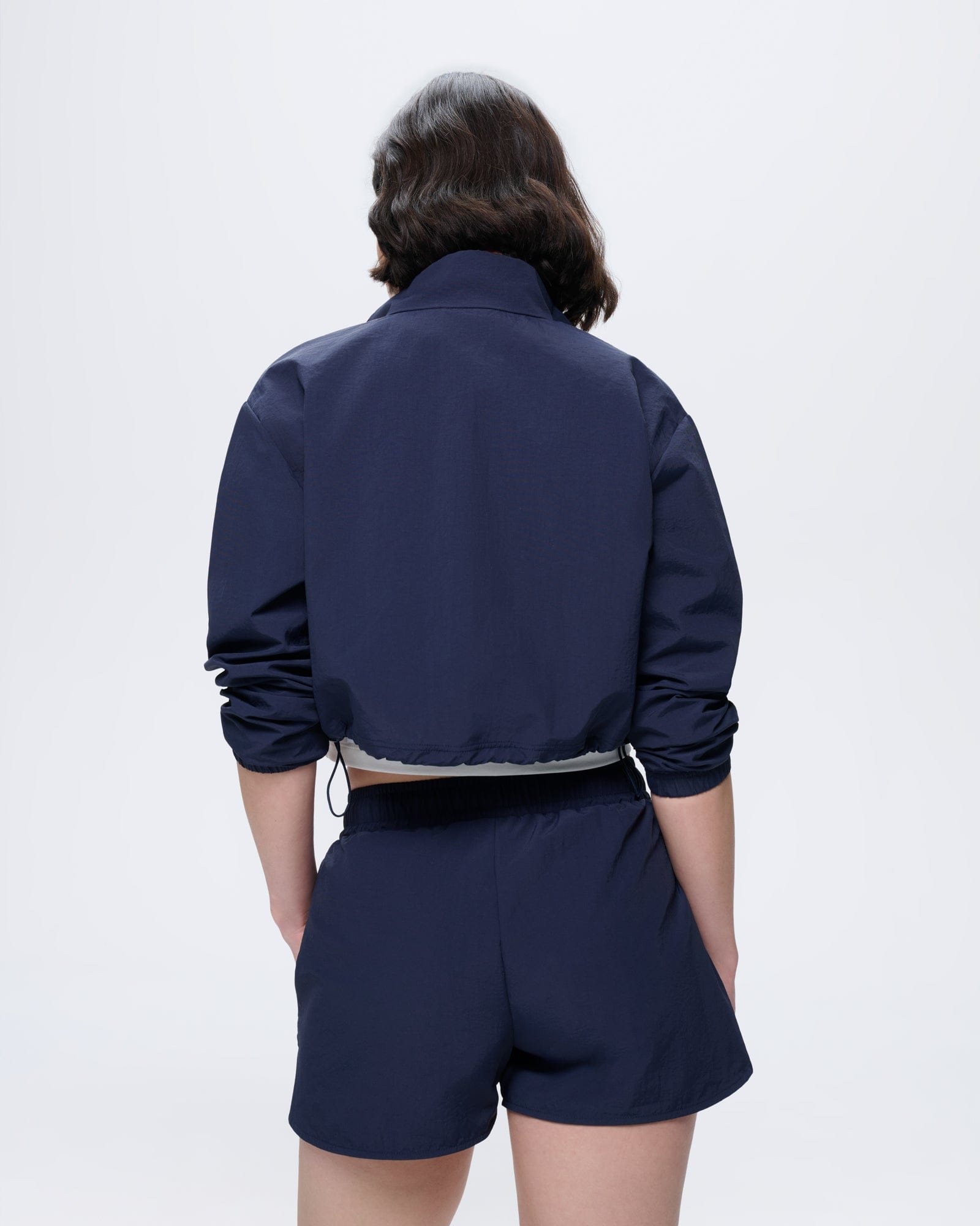 Granite Navy Womens Recycled Polyamide Shorts. Regular fit, lightweight, breathable, worn by model from back