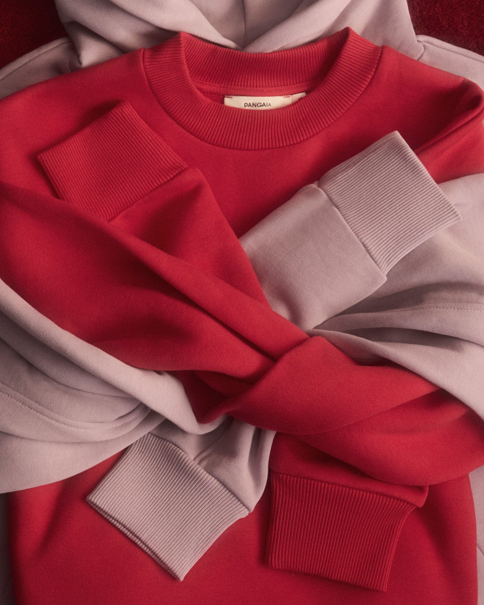 Pangaia red crewneck, mauve hoodie packshot. Premium heavyweight cotton fleece sweatshirts with ribbed cuffs and collar