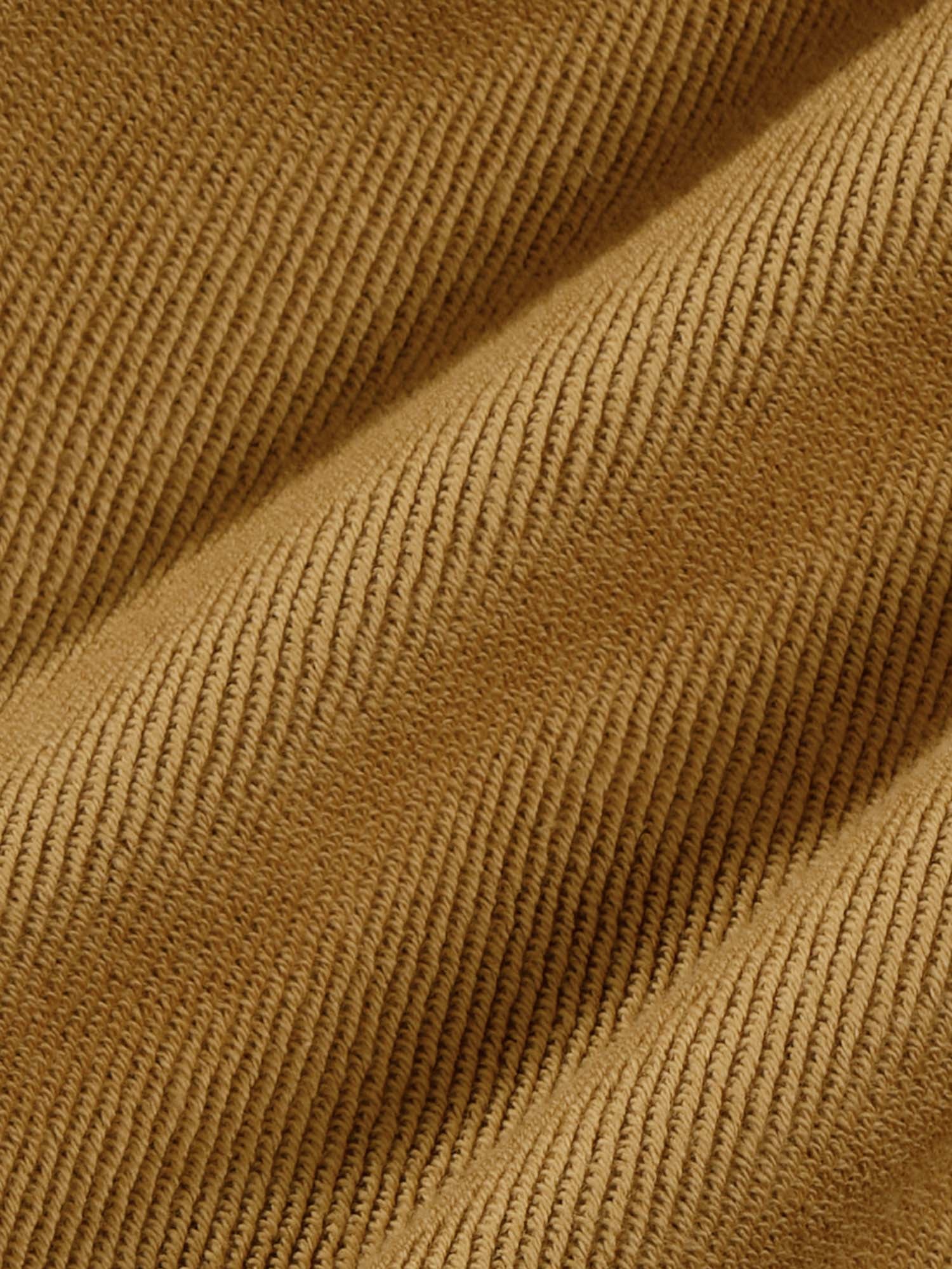 Warm camel brown ribbed knit fabric texture close-up. Soft, tightly knit premium garment material swatch