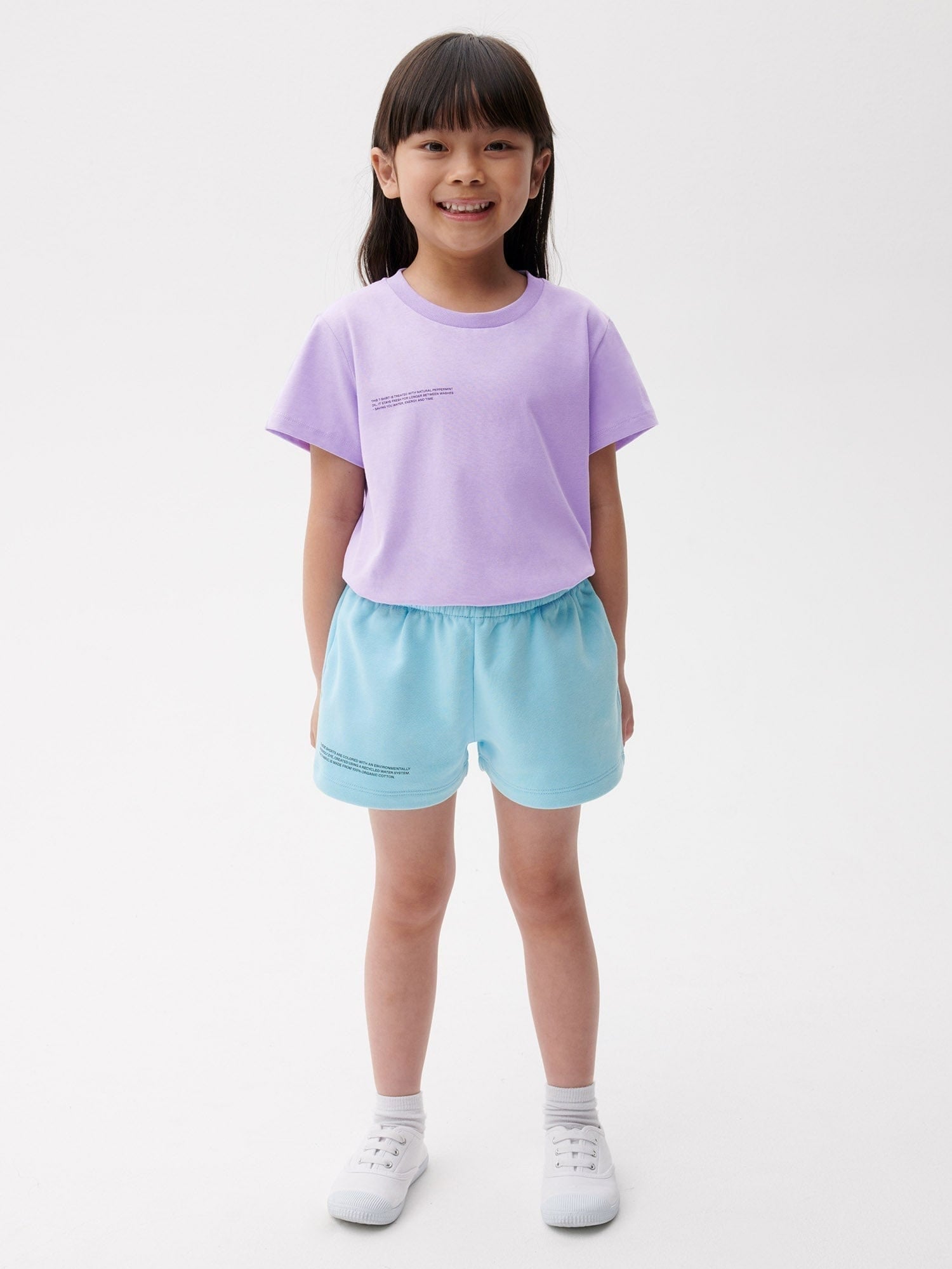 Young girl in a premium lavender short-sleeve cotton t-shirt and light blue jersey relaxed fit shorts