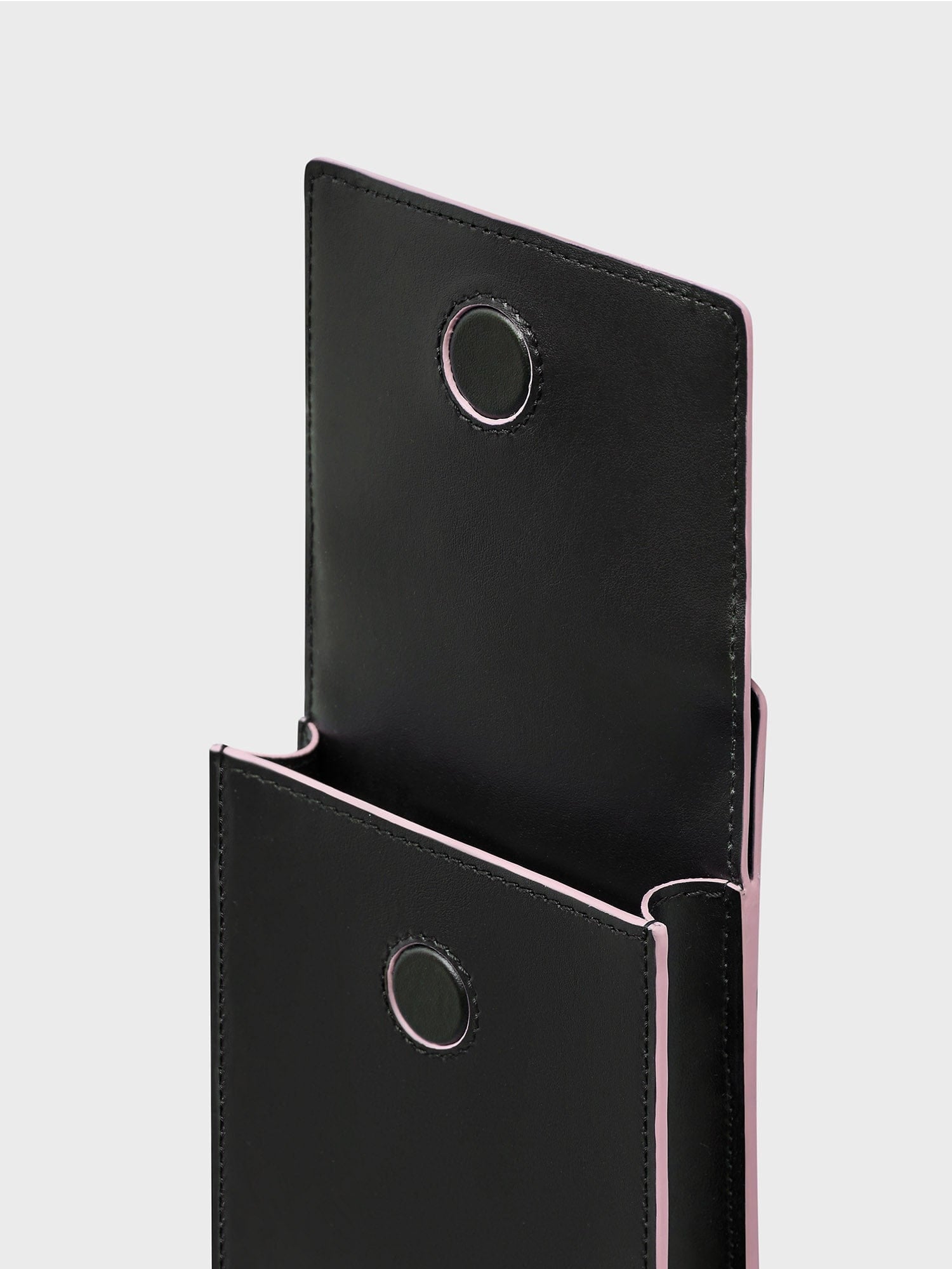 Black plant-based leather alternative Biobased Passport Holder packshot, sakura pink trim, open, compact pouch